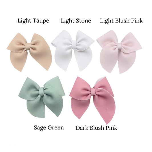 A collection of hair bows in various colors including light taupe, light stone, light blush pink, sage green, and dark blush pink.